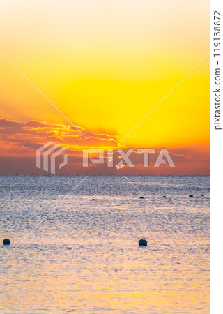 Beautiful yellow and orange sunrise over the sea. Beautiful yellow and orange sunrise over the sea. 119138872