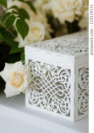 A white box with a floral design sits on a table 119139131