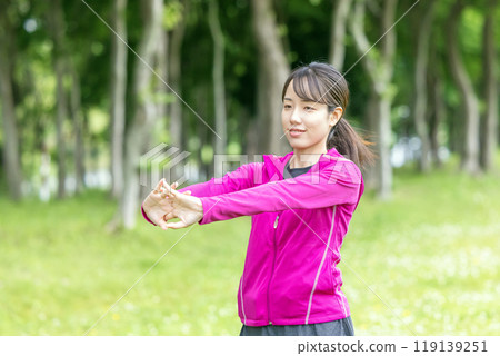 Young woman stretching in the park Young woman stretching in the park 119139251