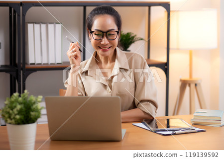 Young asian business woman using laptop for success in modern home office. Young asian business woman using laptop for success in modern home office. 119139592