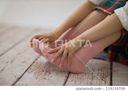 The feet of a young woman putting on socks The feet of a young woman putting on socks 119139709