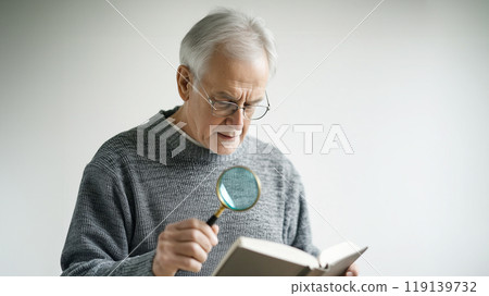 Senior male reading books Senior male reading books 119139732