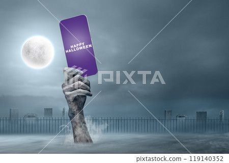 Mummy hands have dirty bandages on them. Mummy, devil, evil, satan, or zombie hands holding a mobile phone with a Happy Halloween sign 119140352