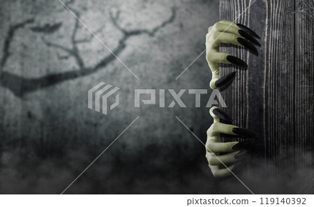 Witch hands reaching out from wooden board, trying to grab something or someone. Empty board for copy space. Scene is scary and creepy. Evil, satan, zombie or a monster hand 119140392