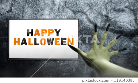 Witches hand with long nail claw is reaching out with a Happy Halloween sign on the screen. The color is green. Evil, zombie, or monster hand. The scene is scary and creepy 119140393