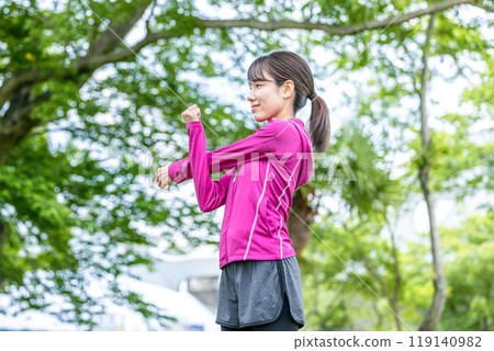 Young woman stretching in the park 119140982