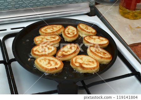Pancakes are fried in a frying pan. Pancakes are fried in a frying pan. 119141804