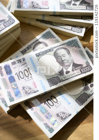 A stack of bills on a table (new bill version) 119142726