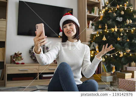 Young woman on video call with Christmas tree background 119142976