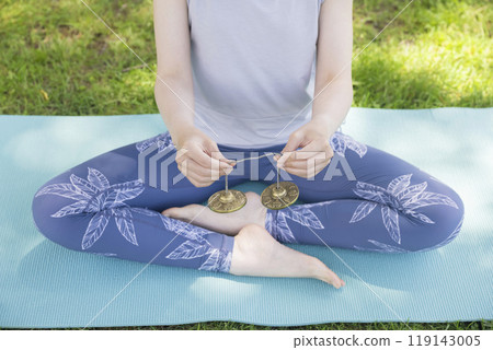 Woman's hands using Tingsha in outdoor yoga Outdoor yoga image Woman's hands using Tingsha in outdoor yoga Outdoor yoga image 119143005