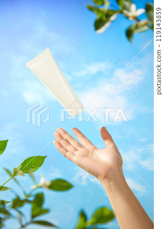 A photograph used to promote the beauty product shows a model hand catching for an unmarked white tube of cream set against a gorgeous blue sky with drifting clouds and some branches. A photograph used to promote the beauty product shows a model hand catching for an unmarked white tube of cream set against a gorgeous blue sky with drifting clouds and some branches. 119143859