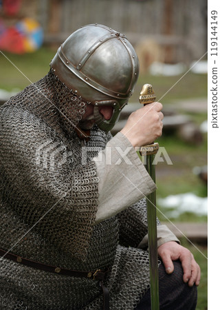 Bowing Medieval Knight in Chainmail Armor Holding Sword Bowing Medieval Knight in Chainmail Armor Holding Sword 119144149