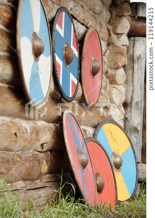 Vibrant Viking Shields Leaning Against Wooden Wall 119144215