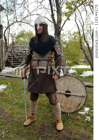 Standing Medieval Knight Holding Sword in Hand 119144278