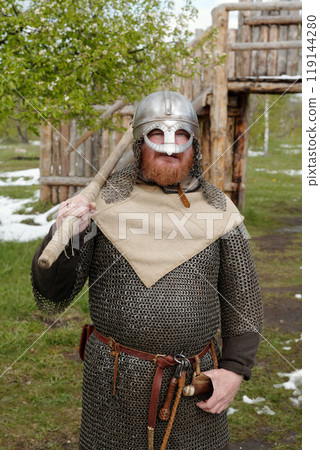 Portrait of Viking Reenactor Standing in Historic Outfit 119144280