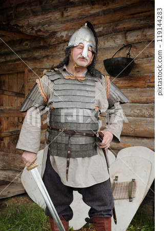Standing Medieval Soldier Holding Sword in Outfit 119144283