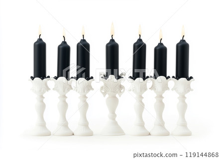 Black candles in stylish holders on a plain white background. Minimalistic display for home Halloween decor concepts Black candles in stylish holders on a plain white background. Minimalistic display for home Halloween decor concepts 119144868
