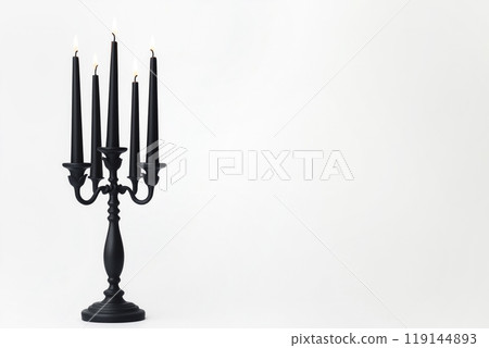 Black candles in stylish holders on a plain white background. Minimalistic display for home Halloween decor concepts Black candles in stylish holders on a plain white background. Minimalistic display for home Halloween decor concepts 119144893