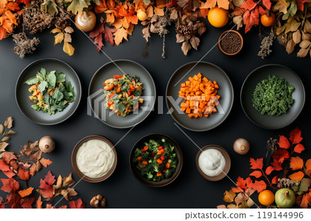 Festive table with various autumn vegetables, fruits, and dishes on black background. Concept of Thanksgiving harvest 119144996