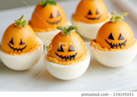 Closeup of deviled eggs garnished with herbs and paprika on white background. Concept of appetizers and holiday food Closeup of deviled eggs garnished with herbs and paprika on white background. Concept of appetizers and holiday food 119145051