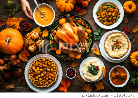 Thanksgiving dinner featuring roast turkey, mashed potatoes, stuffing, peas, sweet potatoes, greens on dark background Thanksgiving dinner featuring roast turkey, mashed potatoes, stuffing, peas, sweet potatoes, greens on dark background 119145175