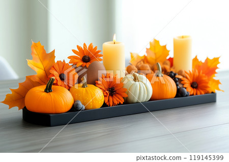 Autumn flat lay featuring pumpkins, candles, and leaves background. Concept of fall, harvest, and Halloween decoration Autumn flat lay featuring pumpkins, candles, and leaves background. Concept of fall, harvest, and Halloween decoration 119145399