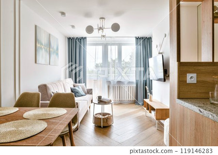 A Modern and Cozy Living Room That Features Abundant Natural Light and Stylish Decor Elements 119146283