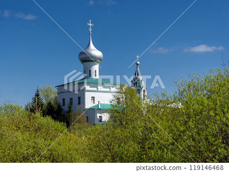 Medieval Russian Church Against Blue Sky and Greenery 119146468