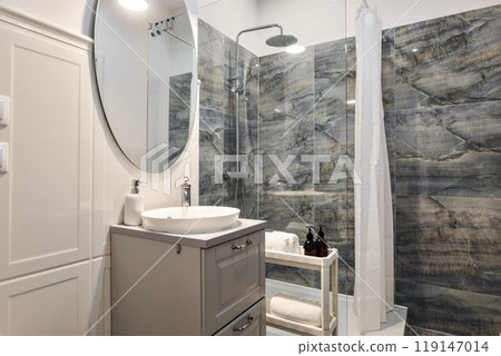 Explore the modern bathroom design that features elegant marble walls and stylish fixtures 119147014