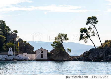 Greece Parga. Panagia island off the coast of Parga, small chapel and trees on the rock 119147033