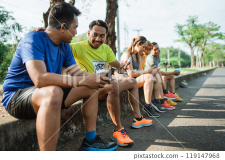 group athlete taking break after running group athlete taking break after running 119147968