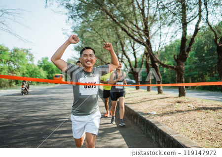 asian runner almost crossing finish line 119147972