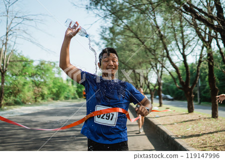 asian runner in sportswear crossing finish line asian runner in sportswear crossing finish line 119147996