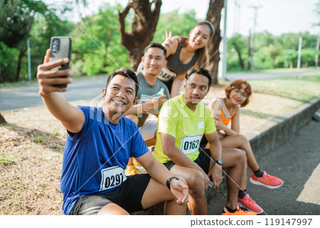 male athlete holding phone for taking photo male athlete holding phone for taking photo 119147997