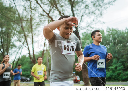 asian male athlete wipes sweat while run 119148050