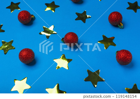 New Year background with yellow shiny stars and red Christmas balls on blue background 119148154