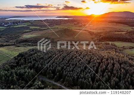 Aerial view of beautiful sunset above Rafoarty and Brenter between Dunkineely and Inver in County Donegal, Republic of Ireland. Aerial view of beautiful sunset above Rafoarty and Brenter between Dunkineely and Inver in County Donegal, Republic of Ireland. 119148207
