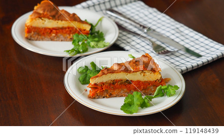 Classic English casserole with meat and potatoes in portions. Mashed potato and ground beef with vegetables. Traditional English homemade breakfast meal dark wooden background. Flat Lay 119148439