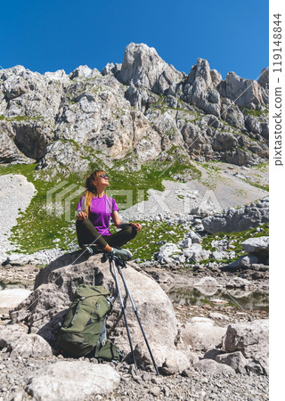 Female Solo Hiker Resting Sitting on Rock Female Solo Hiker Resting Sitting on Rock 119148844