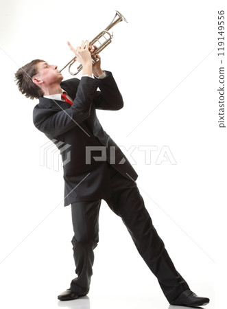 Portrait of a young man playing his Trumpet plays isolated white 119149556