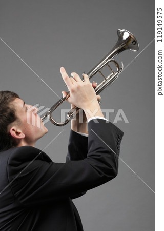 Portrait of a young man playing his Trumpet 119149575