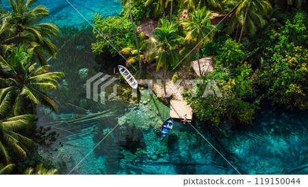 Woman on pier in transparent lake with transparent blue water in Indonesia. Aerial view 119150044