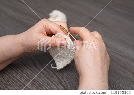 female hands knitting close up 119150363