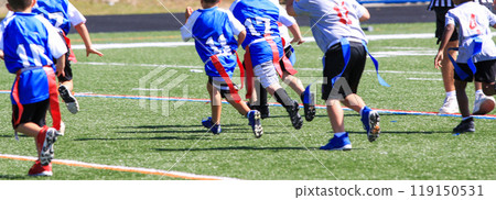 Boys chasing each other playing flag football Boys chasing each other playing flag football 119150531