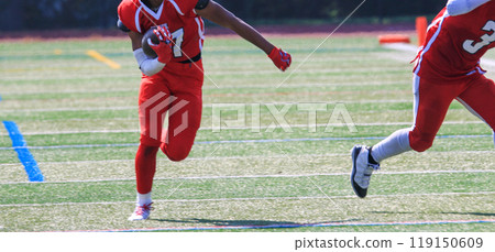 Football player running down the field after catching a pass Football player running down the field after catching a pass 119150609