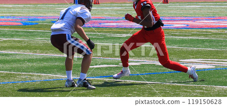 Football wide receiver making a move at the start of a play during a game Football wide receiver making a move at the start of a play during a game 119150628