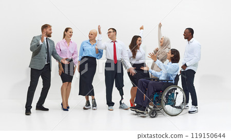 Diverse group of business professionals, including person in wheelchair and man with prosthetic leg, celebrate success with raised hands. Diverse group of business professionals, including person in wheelchair and man with prosthetic leg, celebrate success with raised hands. 119150644