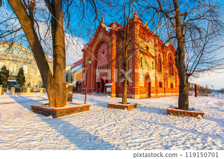 uzhhorod, ukraine - 06 jan 2019: former ashkenazi synagogue. red building on a snow covered square of old town. sunny afternoon uzhhorod, ukraine - 06 jan 2019: former ashkenazi synagogue. red building on a snow covered square of old town. sunny afternoon 119150701