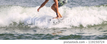 Man catching a wave riding on a kite board hydrofoiling in the ocean 119150724