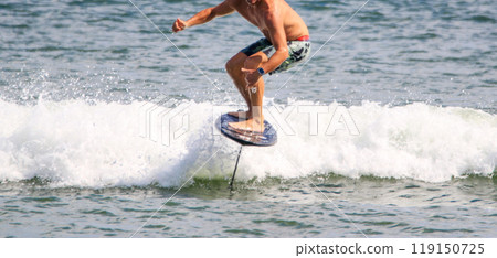 Man hydro foiling on a kite board Man hydro foiling on a kite board 119150725